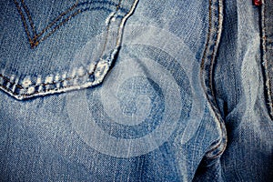 Old blue jeans seam detail cloth of denim for pattern and classic background close up