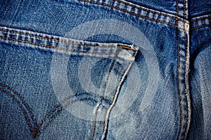 Old blue jeans seam detail cloth of denim for pattern and classic background close up