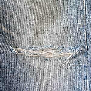 Old blue jeans with torn texture