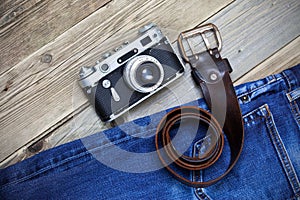 Old blue jeans, vintage leather belt and ancient rangefinder cam