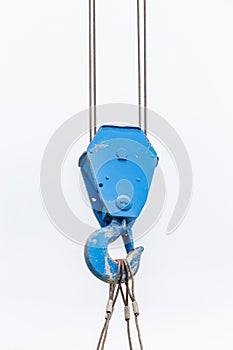 The old blue lifting crane hook is used in construction site on