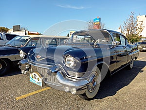 Old blue luxury 1957 Cadillac sedan De Ville four door in a parking. Classic car show.