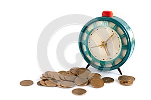 old blue mechanical alarm clock and many coins on a white background