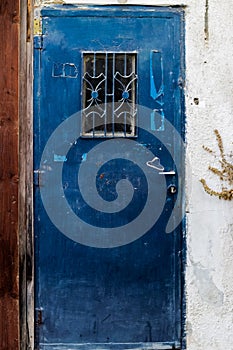 Old blue metal dirt door with keyhole and rusty metal lockas a beautiful vintage background