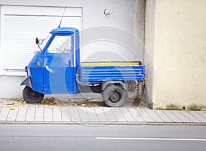 The old blue motor bike with a body