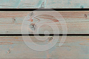 Old blue and orange wooden creaked fence - wood texture background