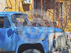 Old blue Russian truck in the yard close up