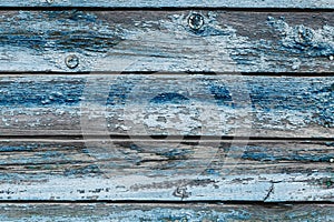Old blue shabby wooden planks with cracked color paint