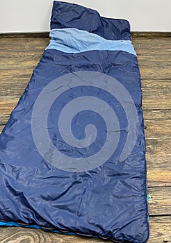 Old blue sleeping bag on the floor