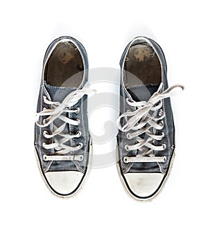 Old blue sneakers isolated on white background