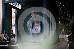 Old blue telephone booth with numbers with cinematic light