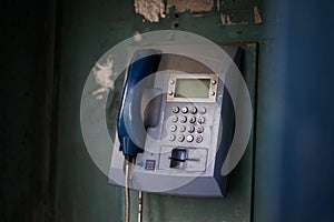 Old blue telephone booth with numbers with cinematic light