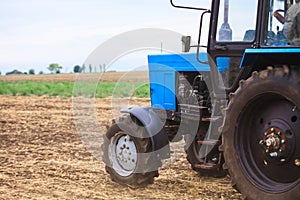 Old blue tractor in a field