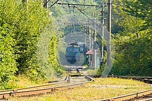 Old blue train is arriving at the platform at the railway station