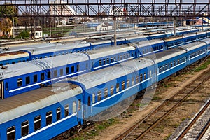 Old blue trains on railway station platform.