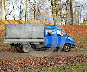 Old blue truck in an autumn garden