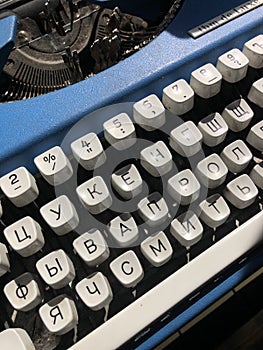 An old blue typewriter with white buttons