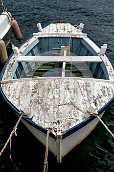 Old blue and white fishing boat with rope