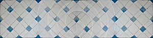 Old blue white vintage shabby patchwork mosaic tiles wallpaper stone concrete cement wall texture background banner, with rhombus