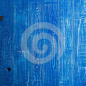 The old blue wood texture with natural patterns. Backgrounds concept - old wooden fence painted in blue background