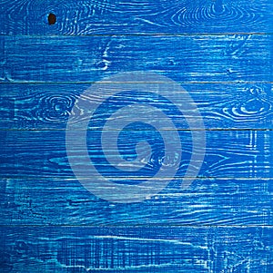 The old blue wood texture with natural patterns. Backgrounds concept - old wooden fence painted in blue background