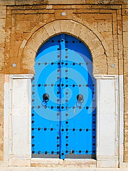 Old blue wooden door in tunisian arabic style