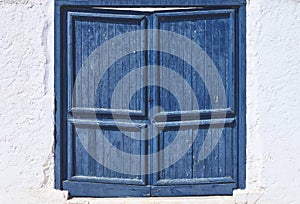 old blue wooden door on a white wall