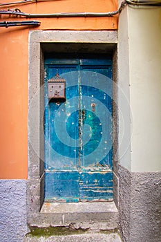 Old blue wooden front door with mailbox