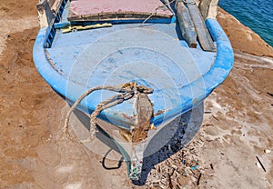 Old blue wooden shabby fishing boat