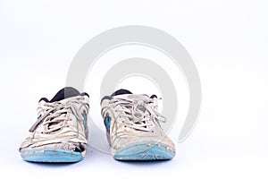 Old blue worn out futsal sports shoes on white background isolated