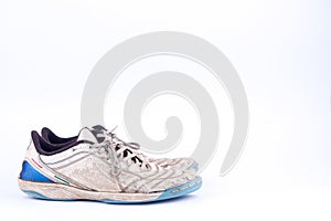 Old blue worn out futsal sports shoes on white background isolated