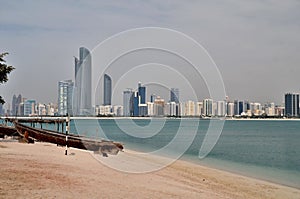 Old boat on the background of skyscrapers in Abu Dhabi