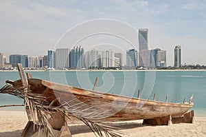 Old boat on the background of skyscrapers in Abu Dhabi