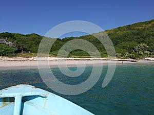 Old boat berthing the idyllic beach of the Cocinas Island photo