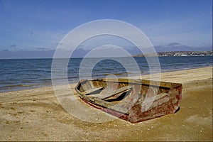 Old boat cape Kazantip summer. Shipwreck on a beach.