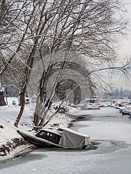 Old boat on the frozen lake