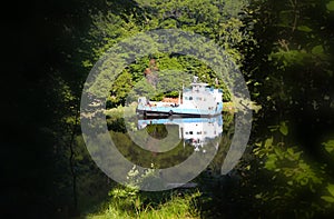 Old boat in the middle of river