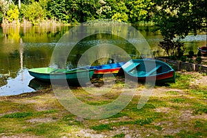 Old boat with oar near river or beautiful lake. Calm sunset on the nature. Fishing boat