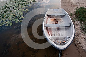 Old boat on an old wooden blue wharf on a river-lake. Top view, close up