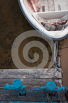 Old boat on an old wooden blue wharf on a river-lake. Top view, close up