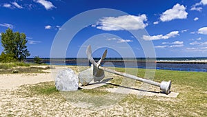 Old boat propeller along the lake Michigan shore.