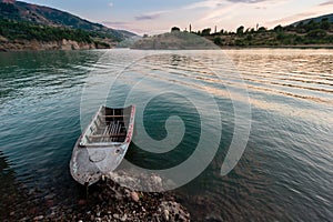 Old boat on the river Pskem at sunset, Western Tien-Shan, Uzbekistan.