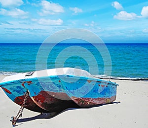 Old boat on the sand in summertime