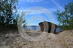 An old boat on the sandy shore