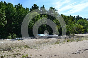 An old boat on the sandy shore