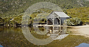 the old boat shed at dove lake on a calm summer morning at cradle mountain national park