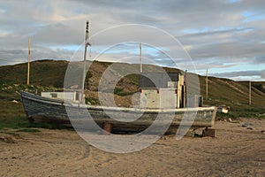 Old boat sitting on a beach in the arctic