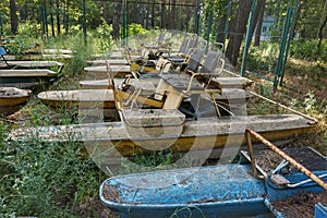 Old boats and catamarans dragged ashore. Rust on the meadow among the grass.