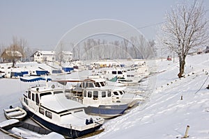 Old boats in frozen marina photo