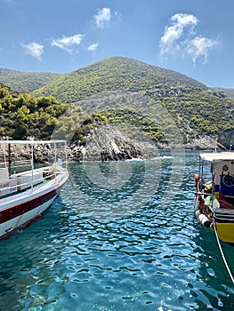 old boats on the sea near mountains on island of greece